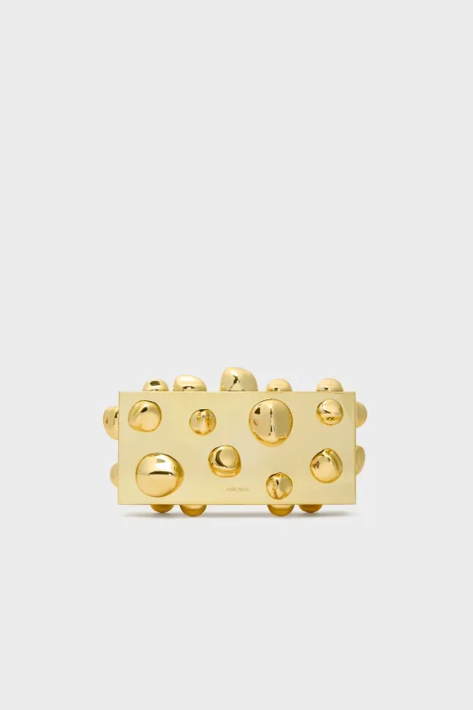 Shiny Gold Orbs Clutch sold by Tuckernuck