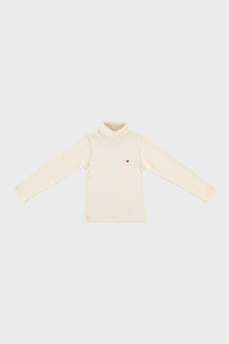 Bebe Heart Turtleneck sold by Tuckernuck