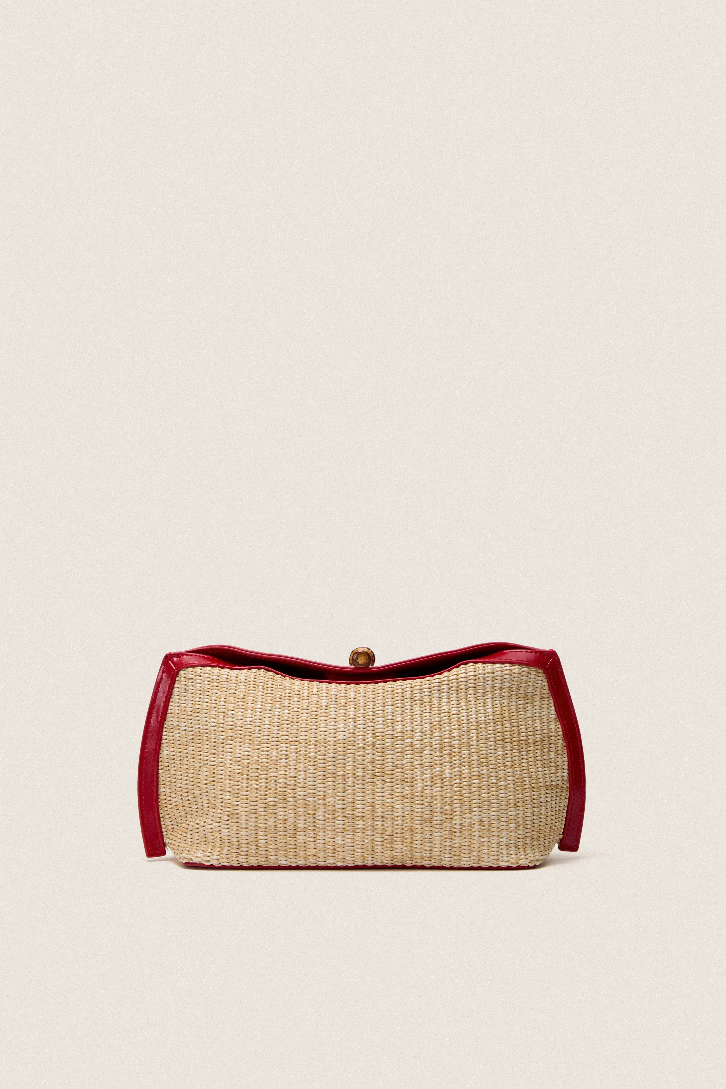 Cherry and Raffia Lock Clutch sold by Tuckernuck