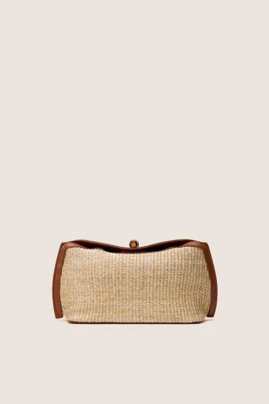 Cognac and Raffia Lock Clutch sold by Tuckernuck