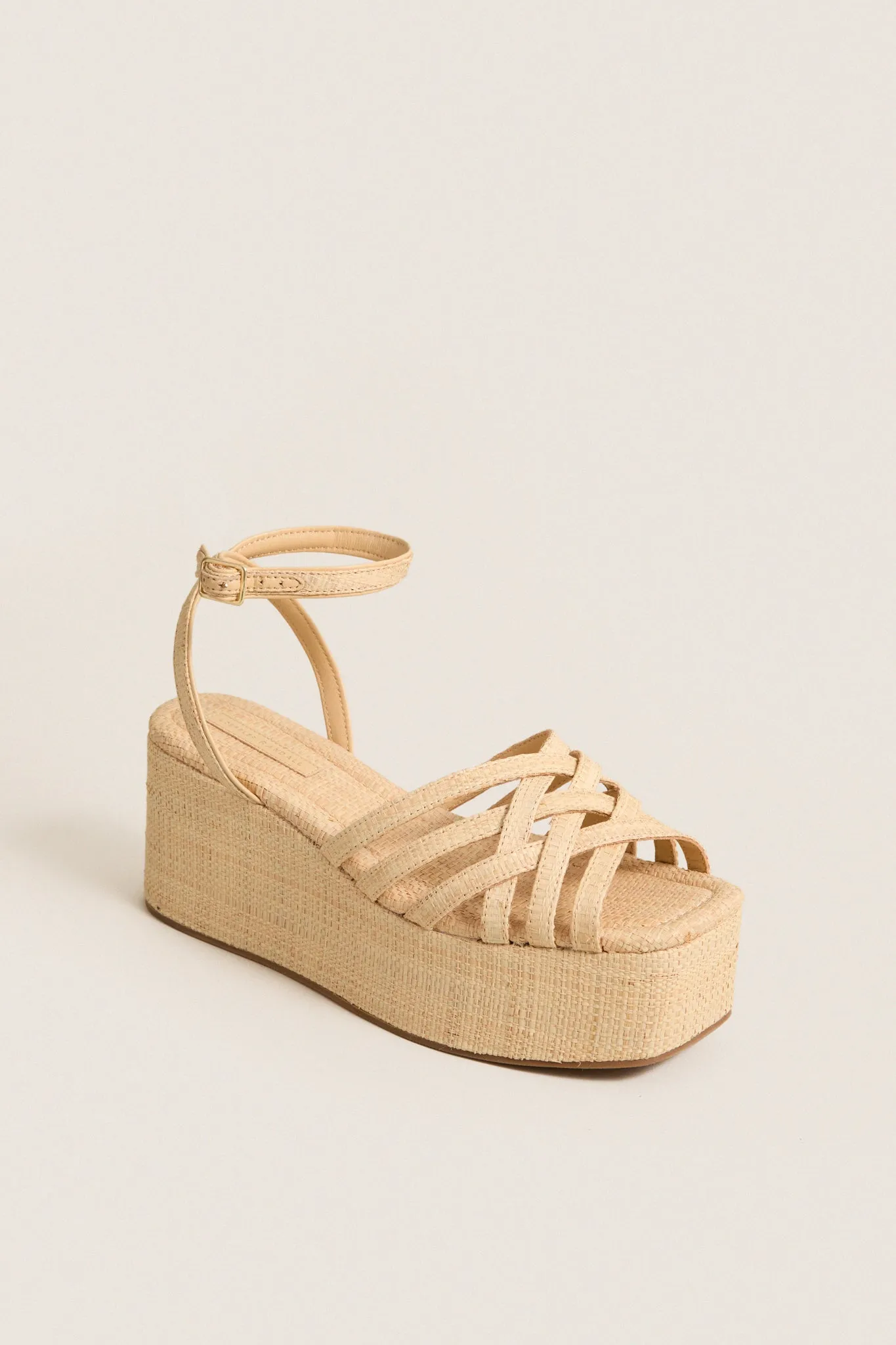 Natural Raffia Channing Platforms sold by Tuckernuck
