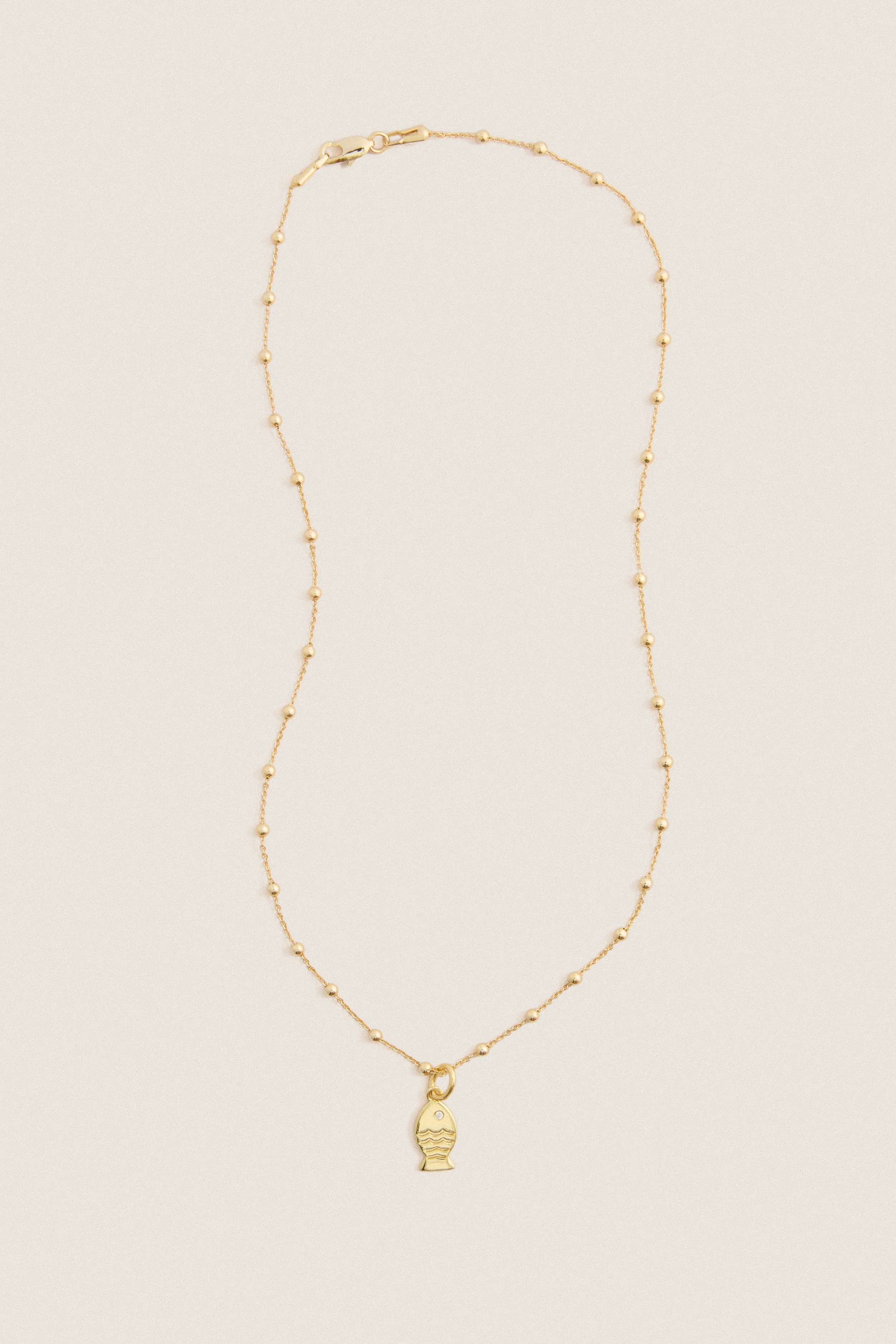 Gold Fish Mini Charm Necklace sold by Tuckernuck