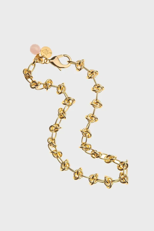 In a Knot Chain with Rose Quartz Bead sold by Tuckernuck