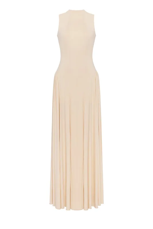 Nude sleeveless mock neck dress with a pleated maxi skirt sold by Milla