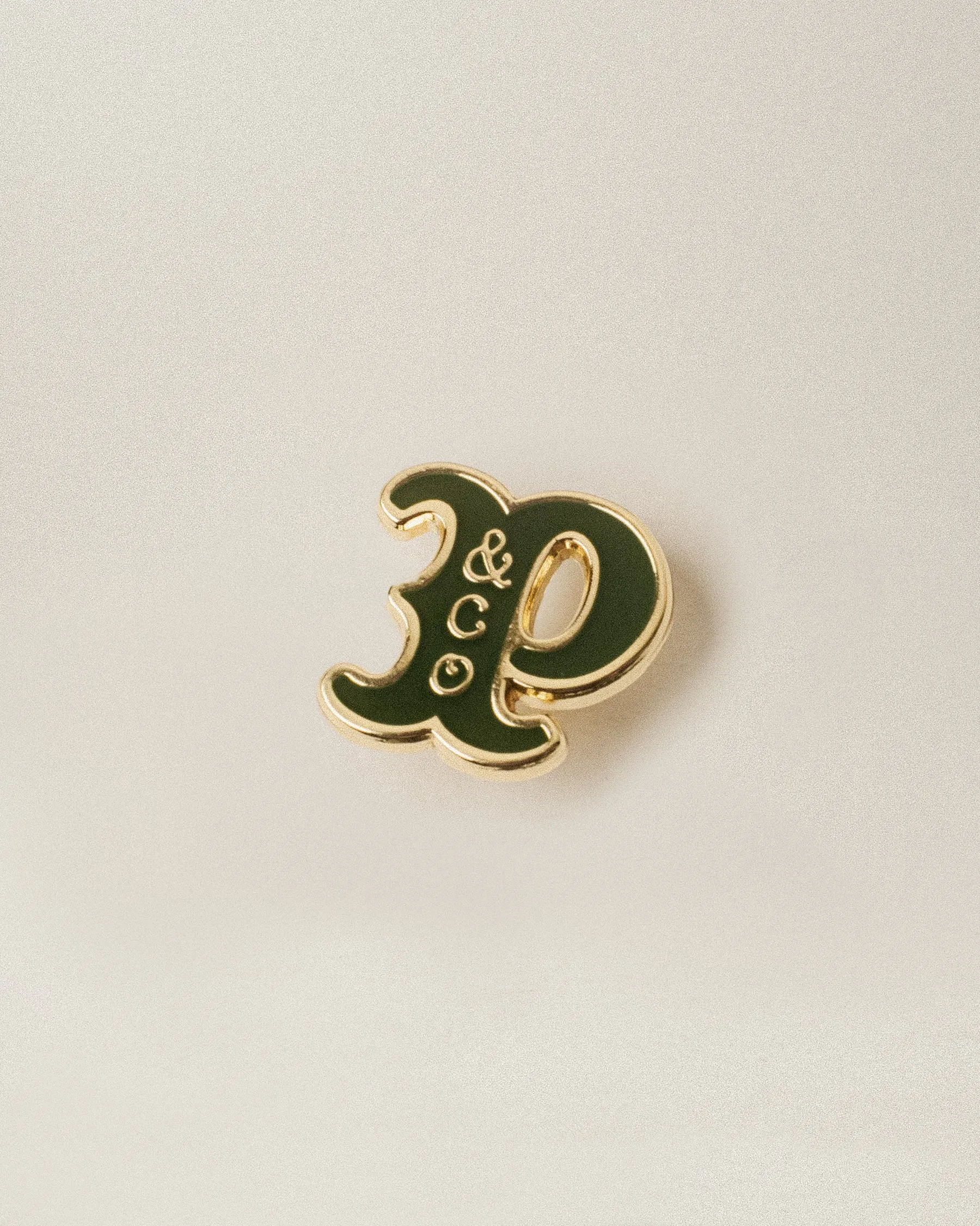 Varsity Pin - Brass & Green sold by P & Co