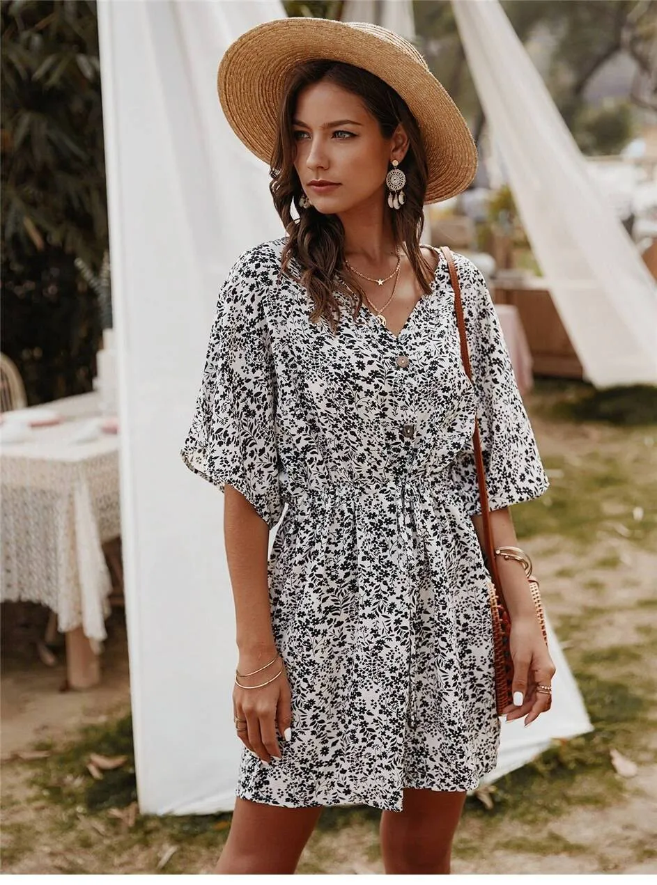 Hippie chic white dress with floral-style patterns sold by Boho Mood