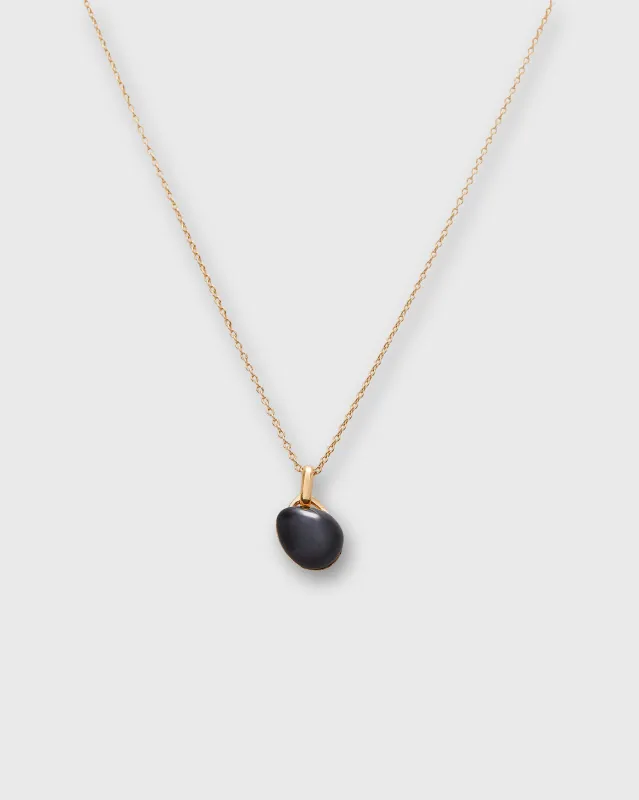 Tiny Ceramic Egg Pendant Necklace in Soot/Gold sold by Mashburn
