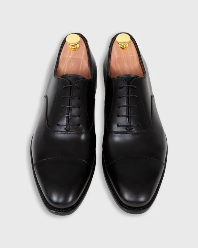 Cap-Toe Oxford in Black Calfskin sold by Mashburn