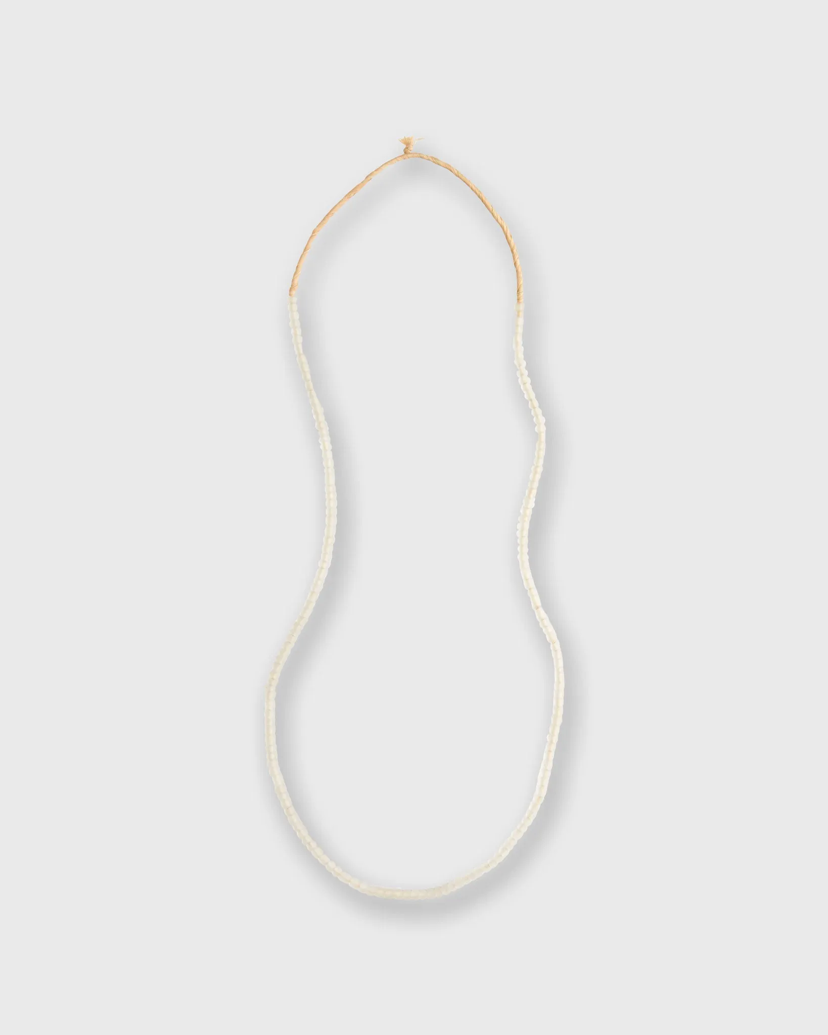 Very Small African Beads in Translucent White sold by Mashburn