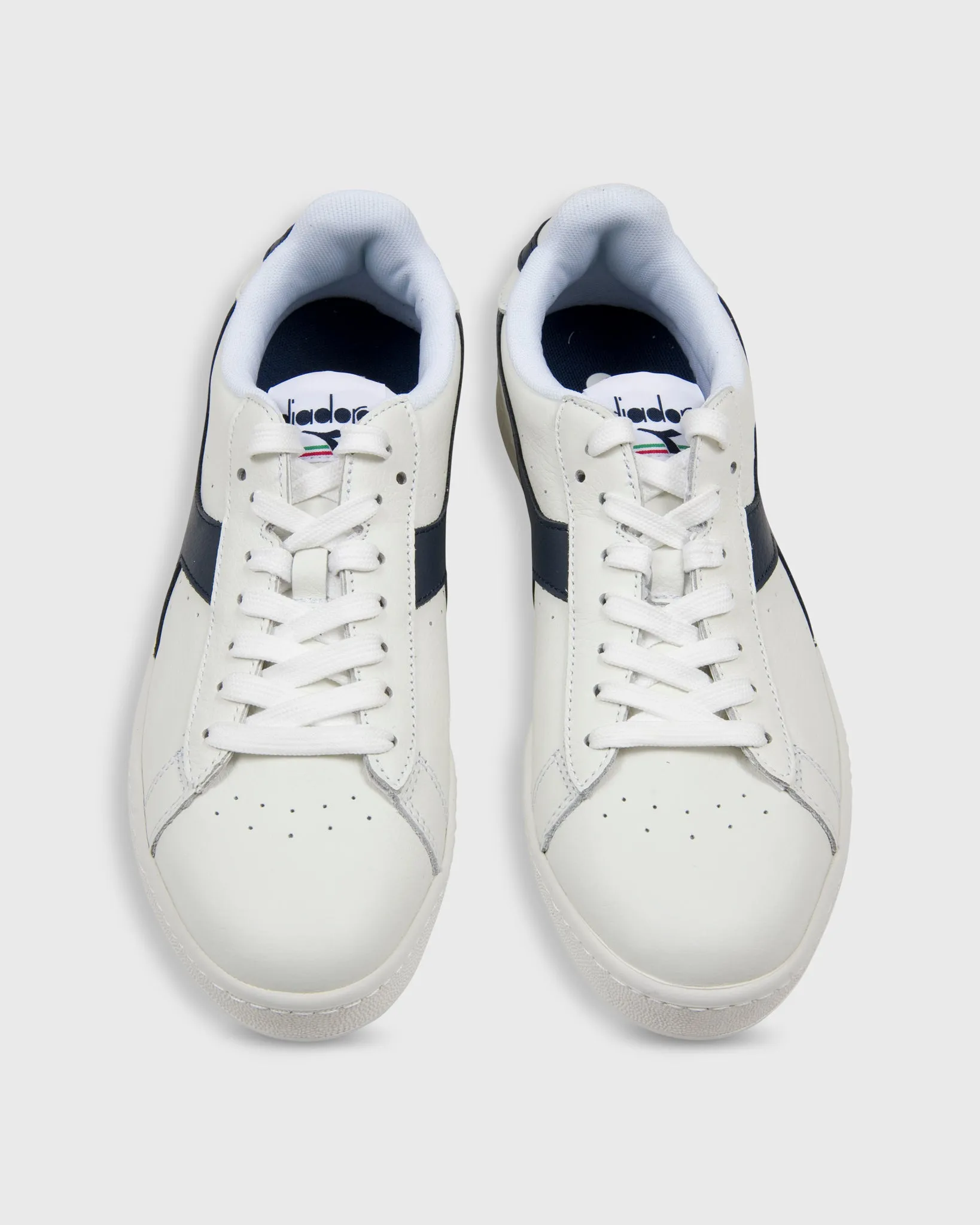 Game L Low Sneaker in White/Navy sold by Mashburn