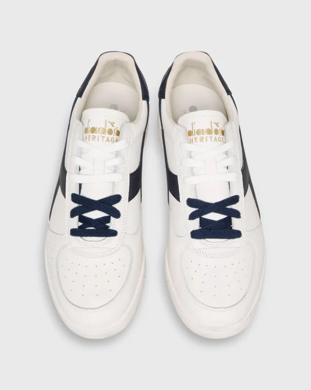 B. Elite Domino Sneaker in White/Peacoat sold by Mashburn