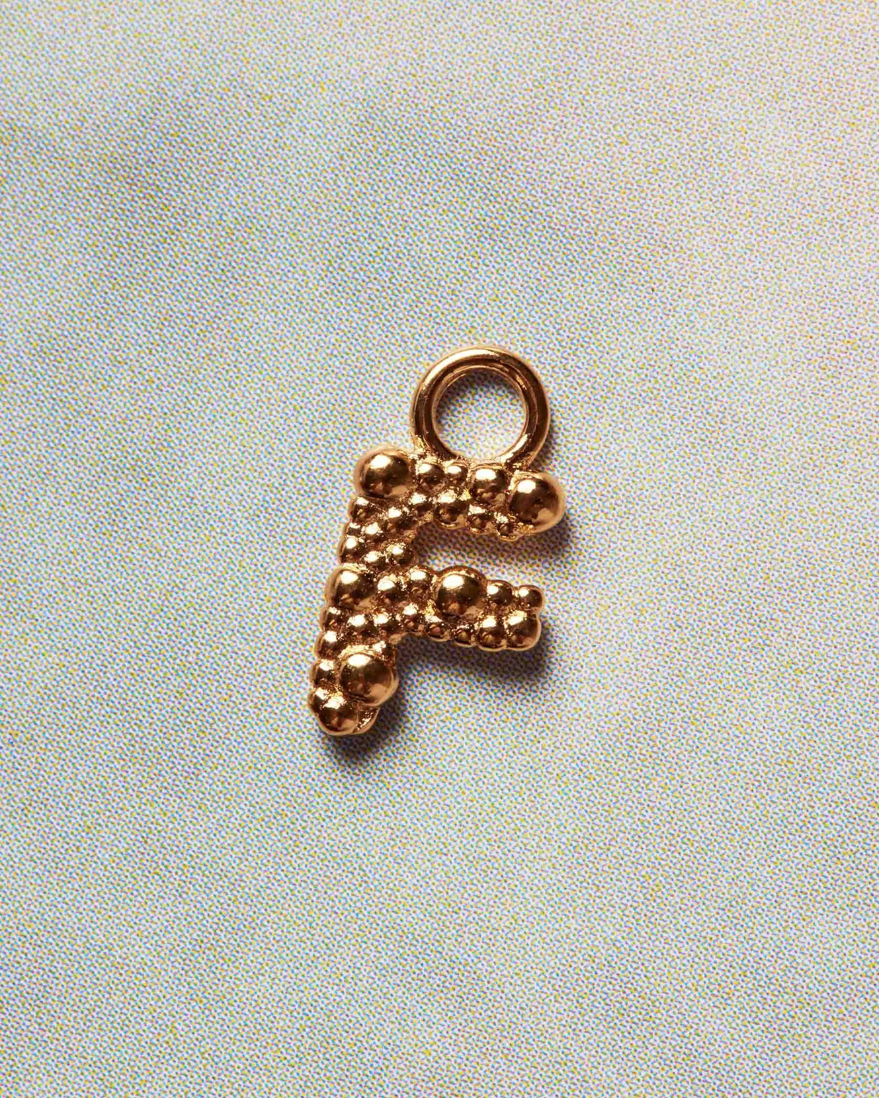 Charm Sand Dust Letter F sold by Apodemia