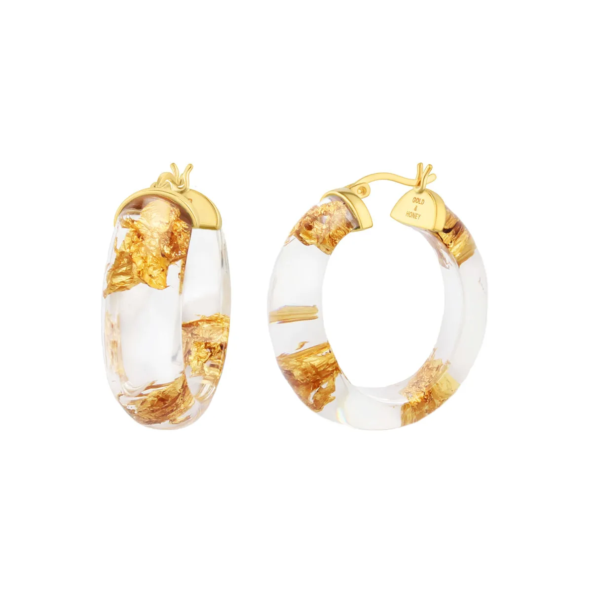 Mini Gold Lucite Full Hoops in Clear sold by The Jewelry Edit