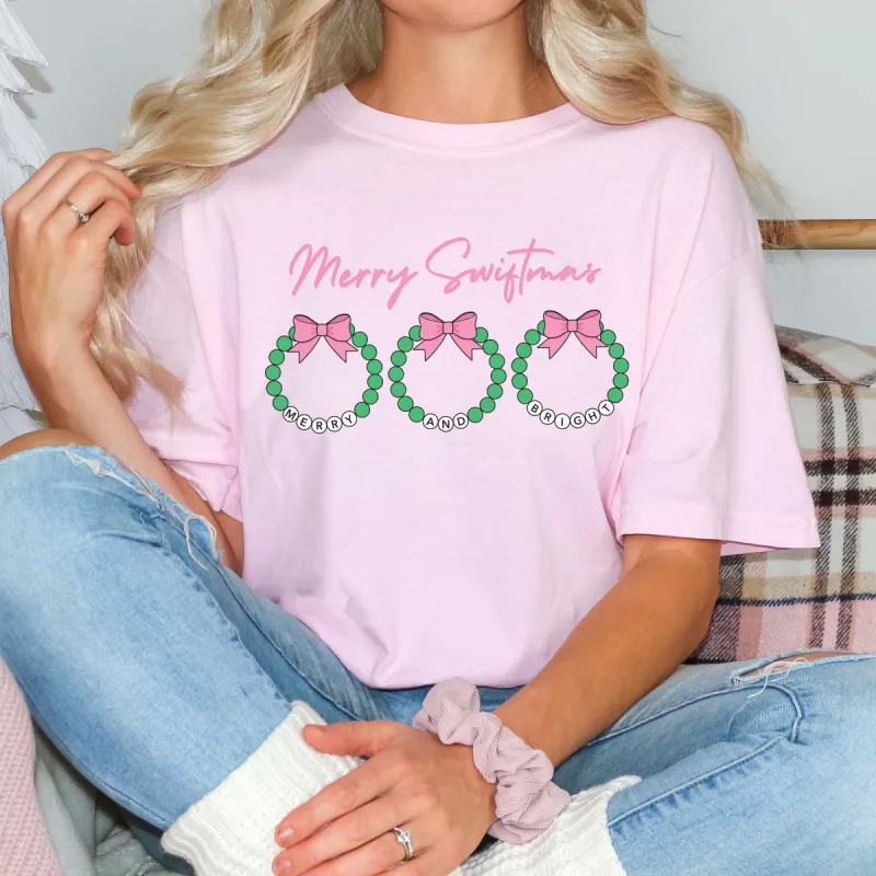 Merry Swiftmas Bracelet Wreaths Comfort Color Graphic Tee sold by Roxie’s Picks