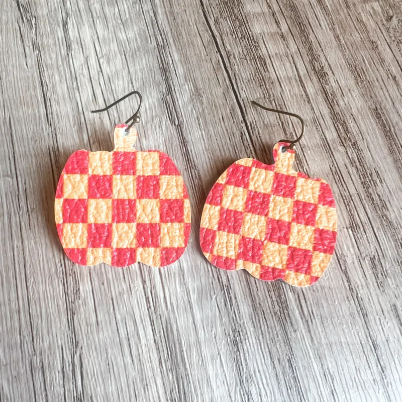 Coral Checkered Pumpkin Earrings sold by Roxie’s Picks