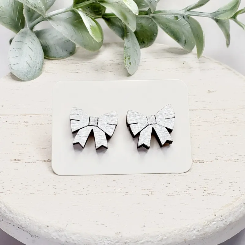Silver Metallic Bow Studs sold by Roxie’s Picks