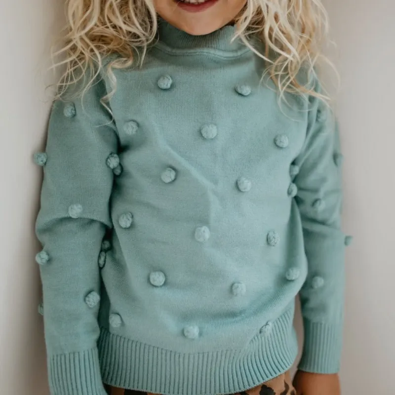 Teal Pom Sweater sold by Roxie’s Picks
