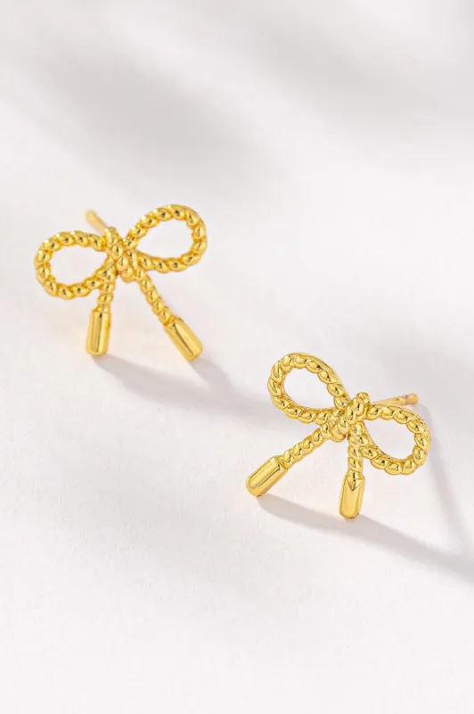 Small textured brass bow stud earrings sold by Roxie’s Picks