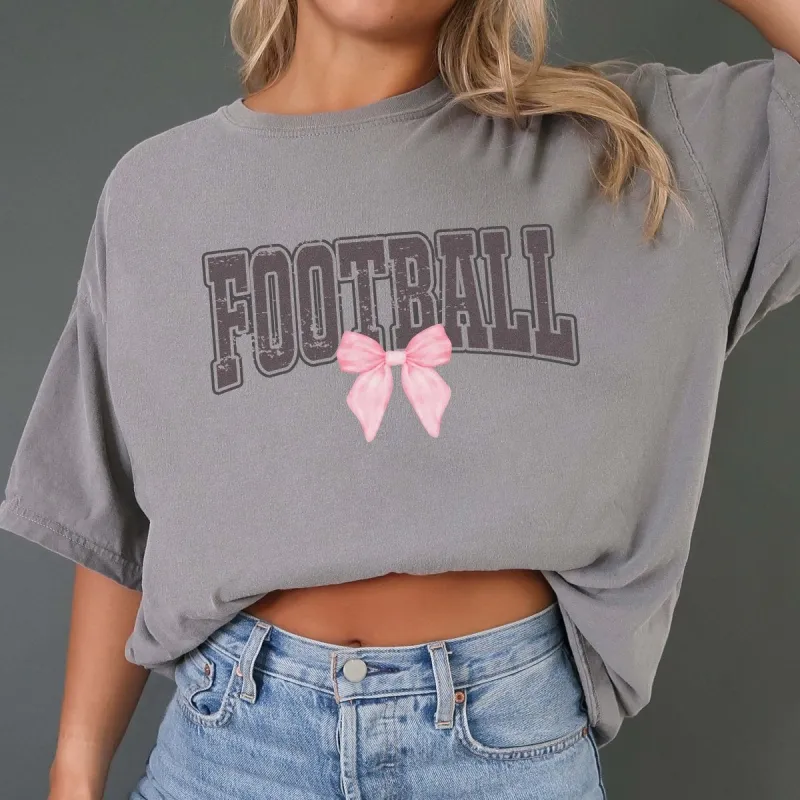 Distressed Football Pink Bow Comfort Color Tee sold by Roxie’s Picks