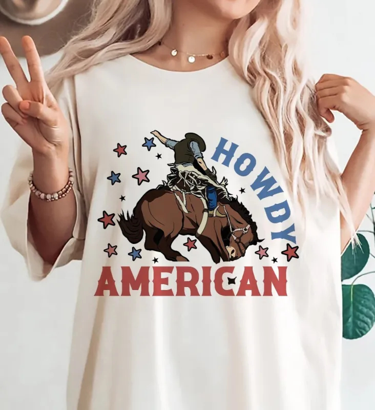 Howdy American Cowboy Riding A Bull T-Shirt or Crew Sweatshirt sold by Roxie’s Picks