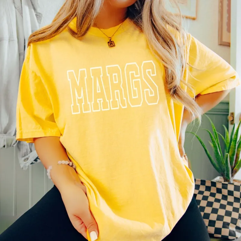 Margs Collegiate Lettering Comfort Color Tee sold by Roxie’s Picks