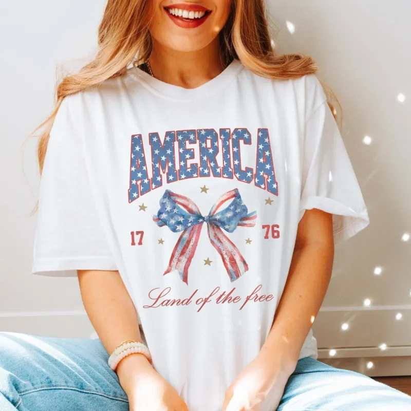 America Land Of The Free Bow Comfort Color Tee sold by Roxie’s Picks