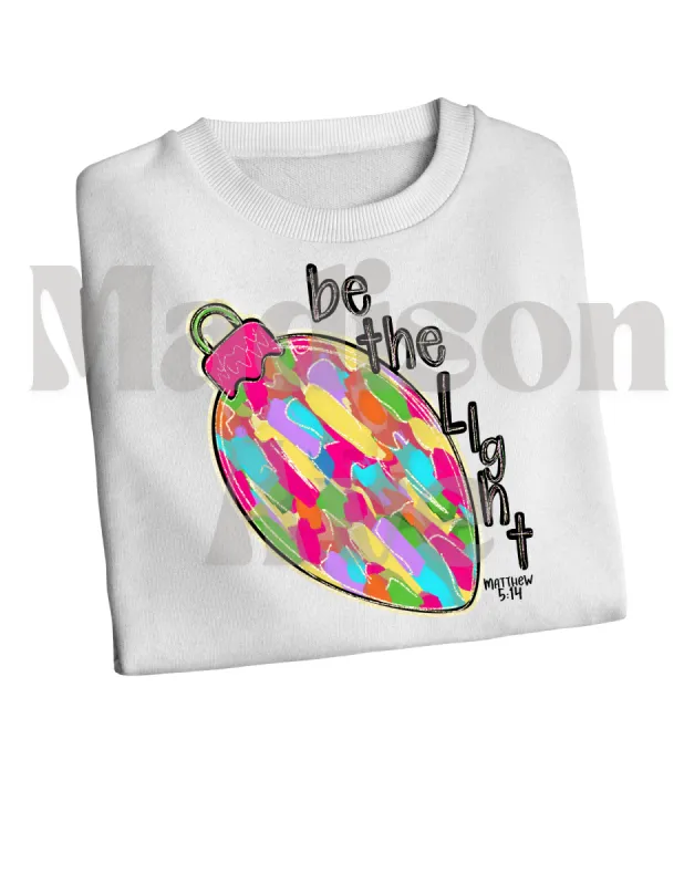 Be the Light Christmas Light sweatshirt sold by Roxie’s Picks