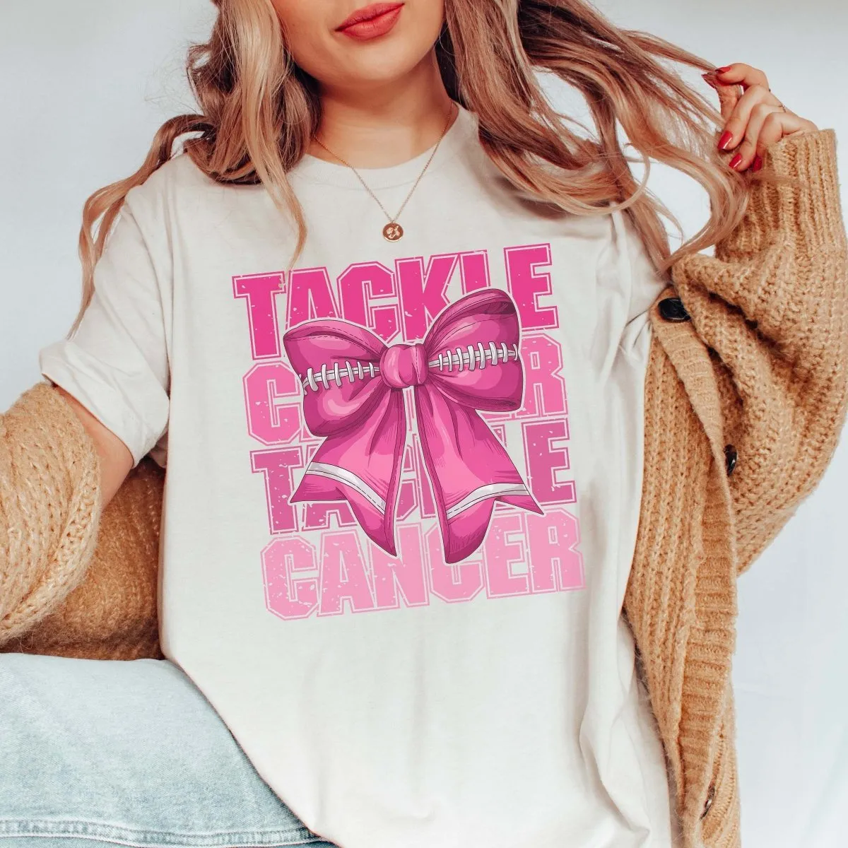 Tackle Cancer Football Bow Bella Graphic Tee sold by Roxie’s Picks product image thumbnail 3