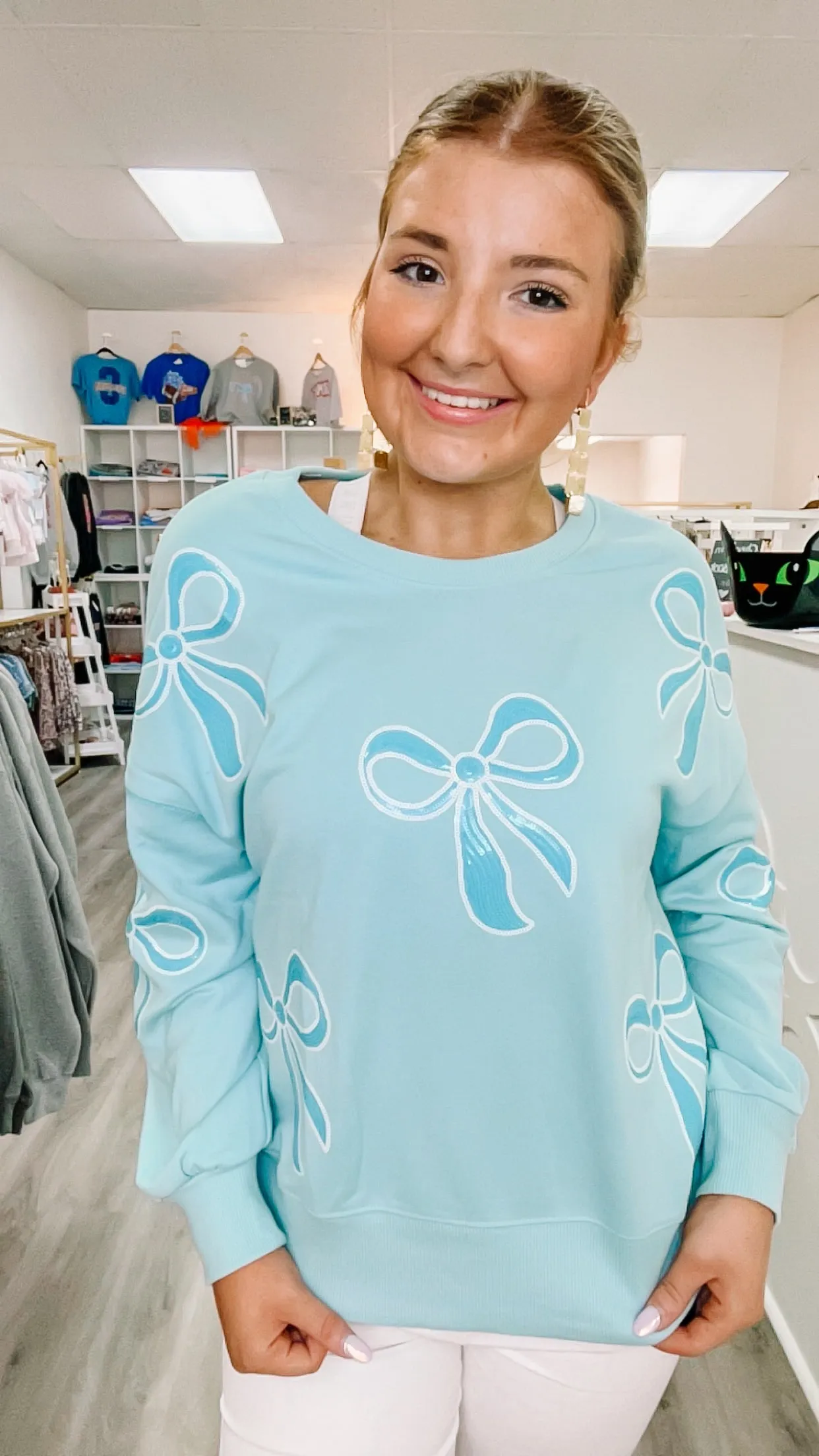 blue sequin bow sweater sold by Roxie’s Picks