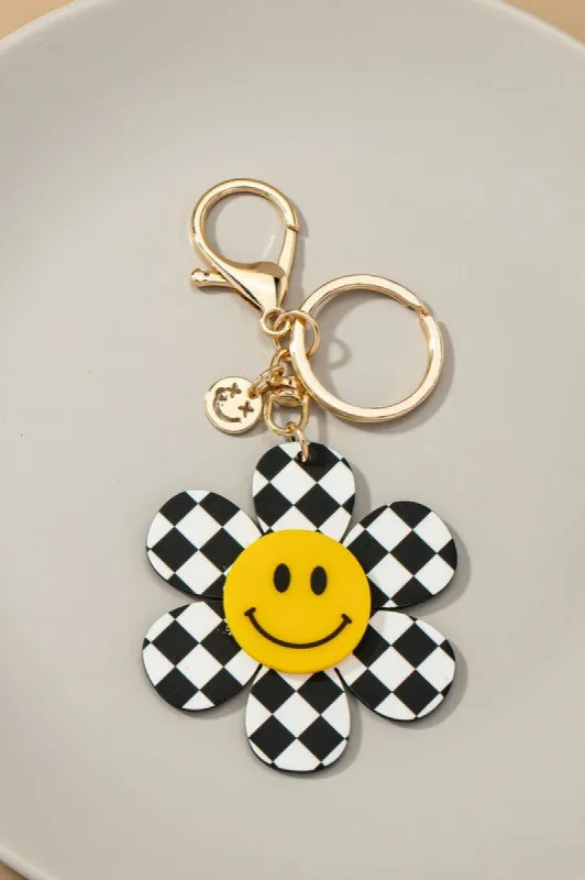Big checker flower key chain with smiley face sold by Roxie’s Picks