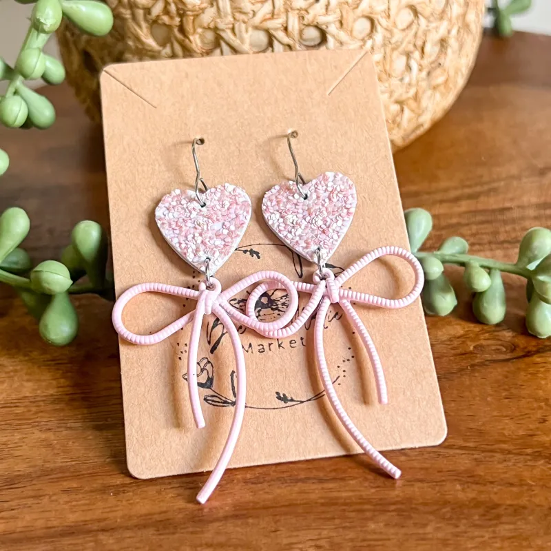 Jasamine Pink Glitter Heart & Bow Earrings sold by Roxie’s Picks