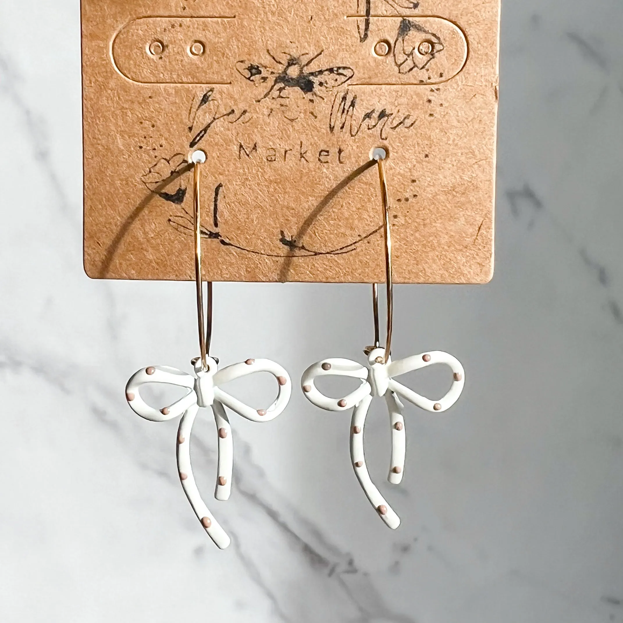 Darla White & Tan Polka Dot Hoop Earrings sold by Roxie’s Picks