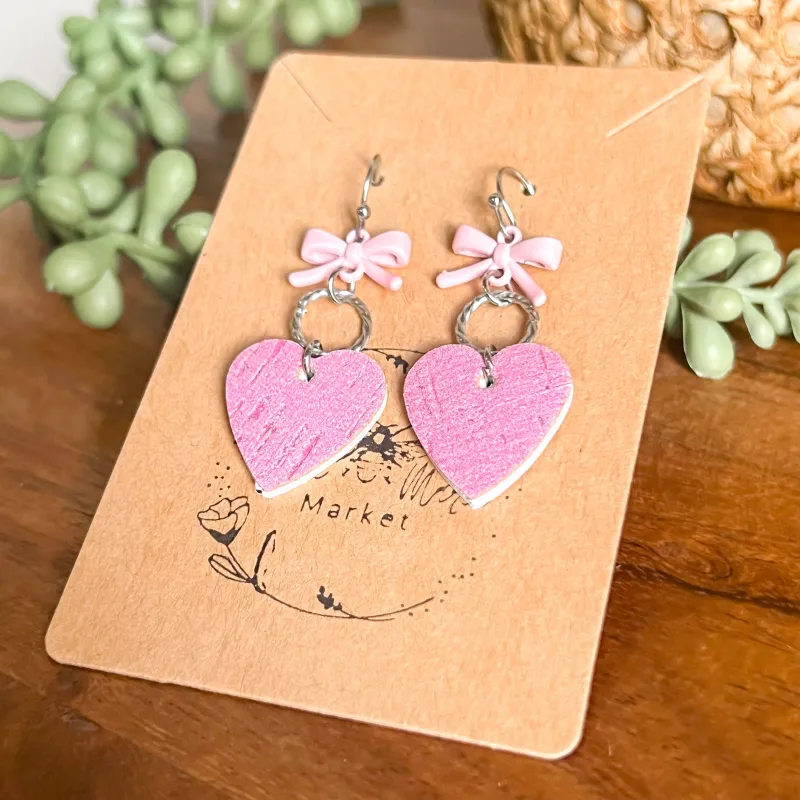 Cara Bubble Gum Pink Heart & Bow Earrings sold by Roxie’s Picks