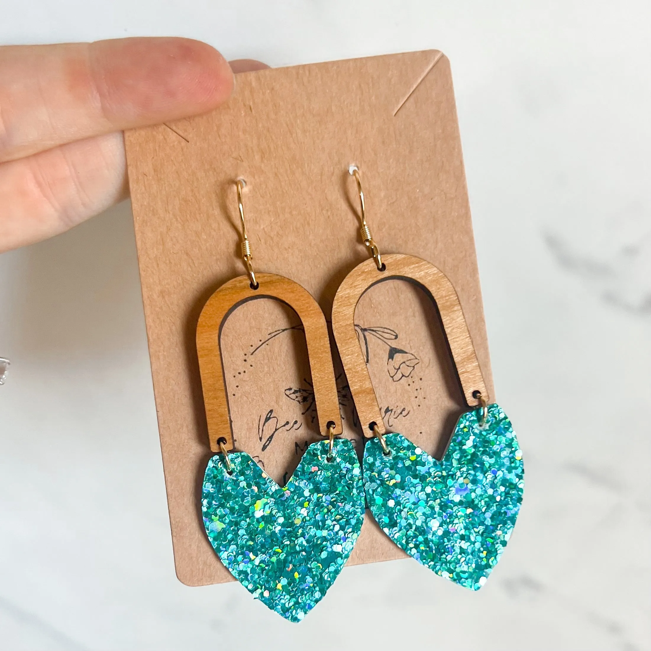 Bianca Teal Glitter Heart & Arch Earrings sold by Roxie’s Picks