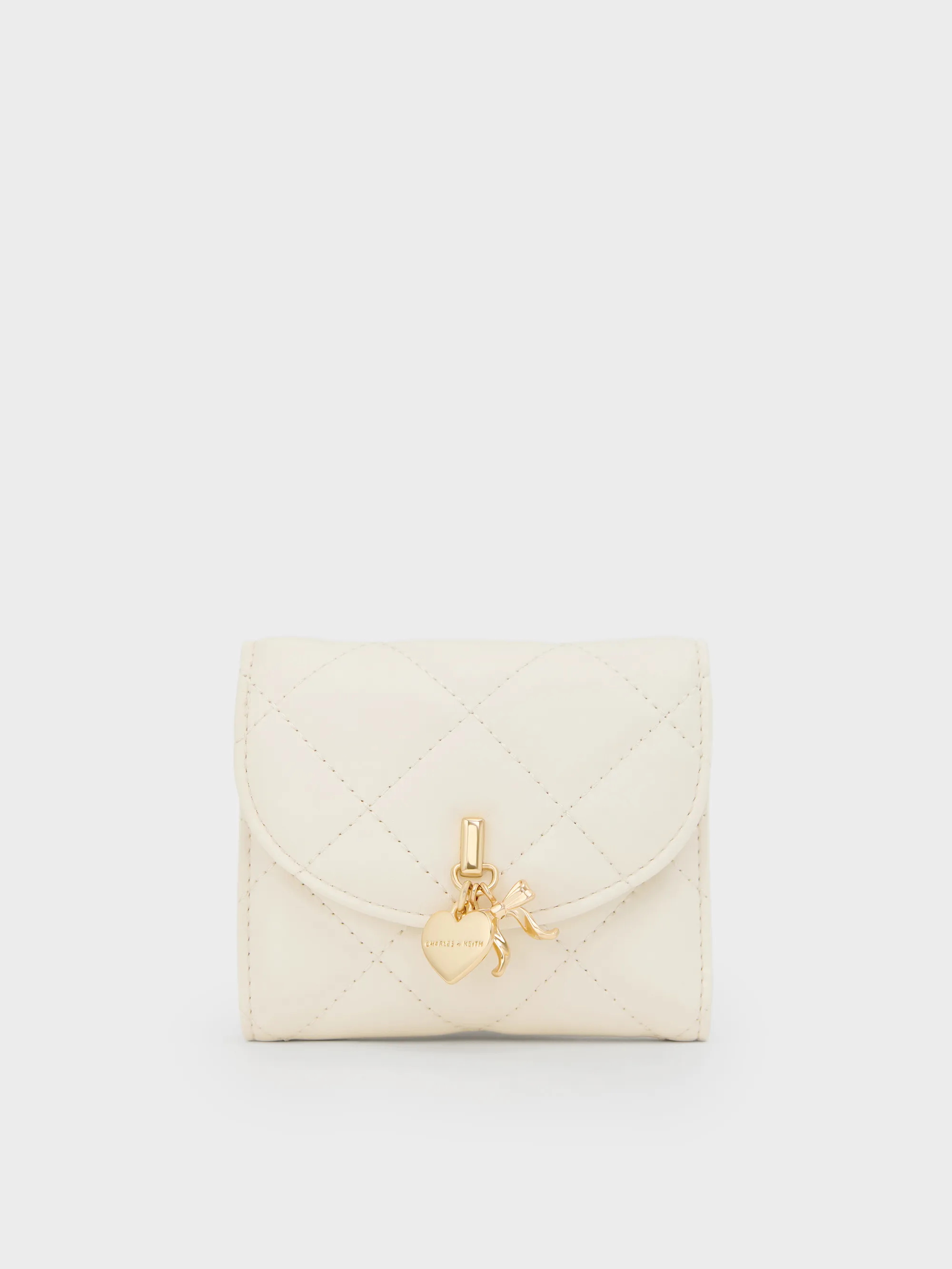 Charles & Keith - Arrietty Quilted Bow-Heart Charm Curved-Flap Wallet sold by Charles & Keith