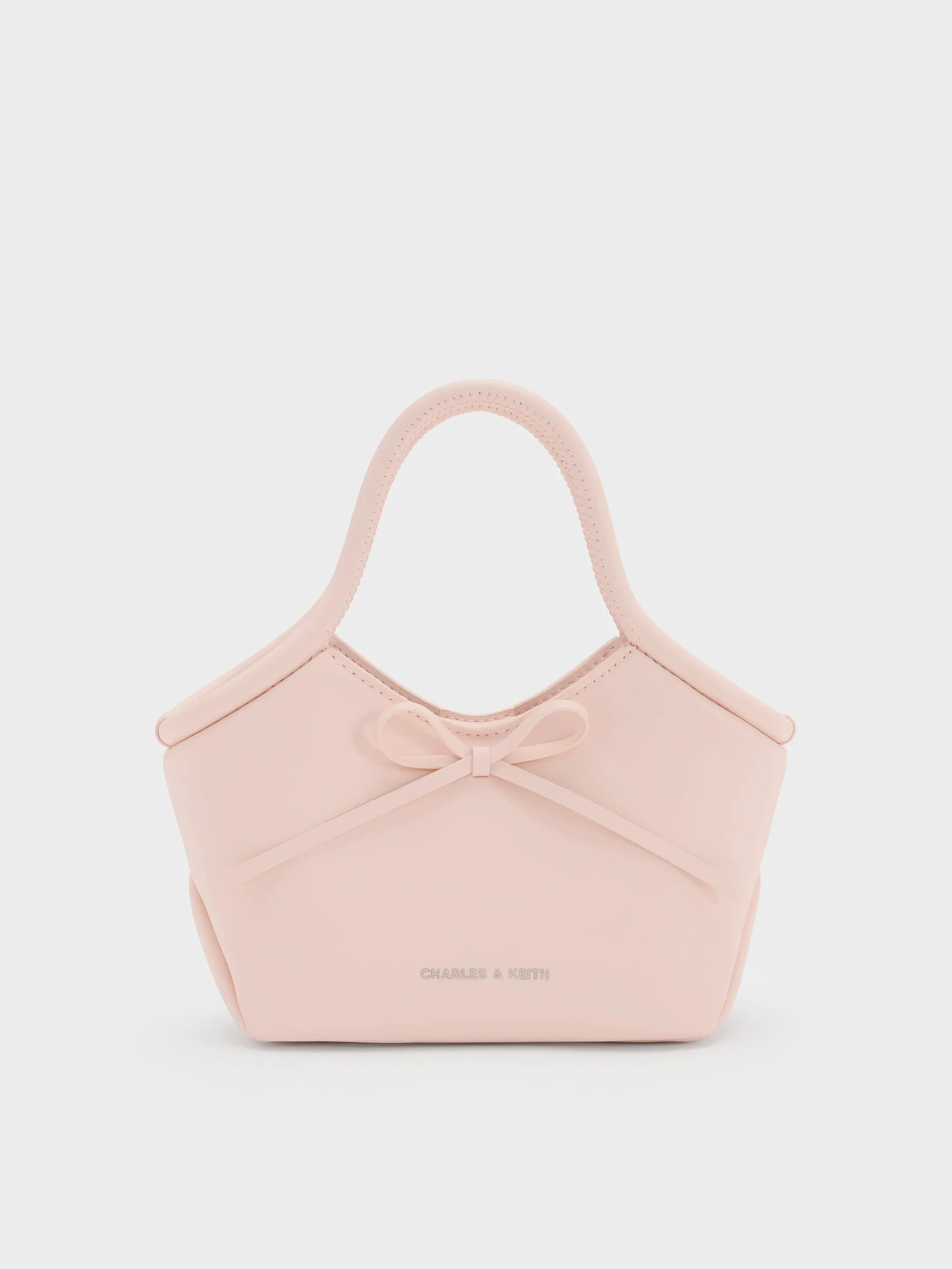 CHARLES & KEITH - Hazel Bow Tubular Top Handle Bag sold by Charles & Keith