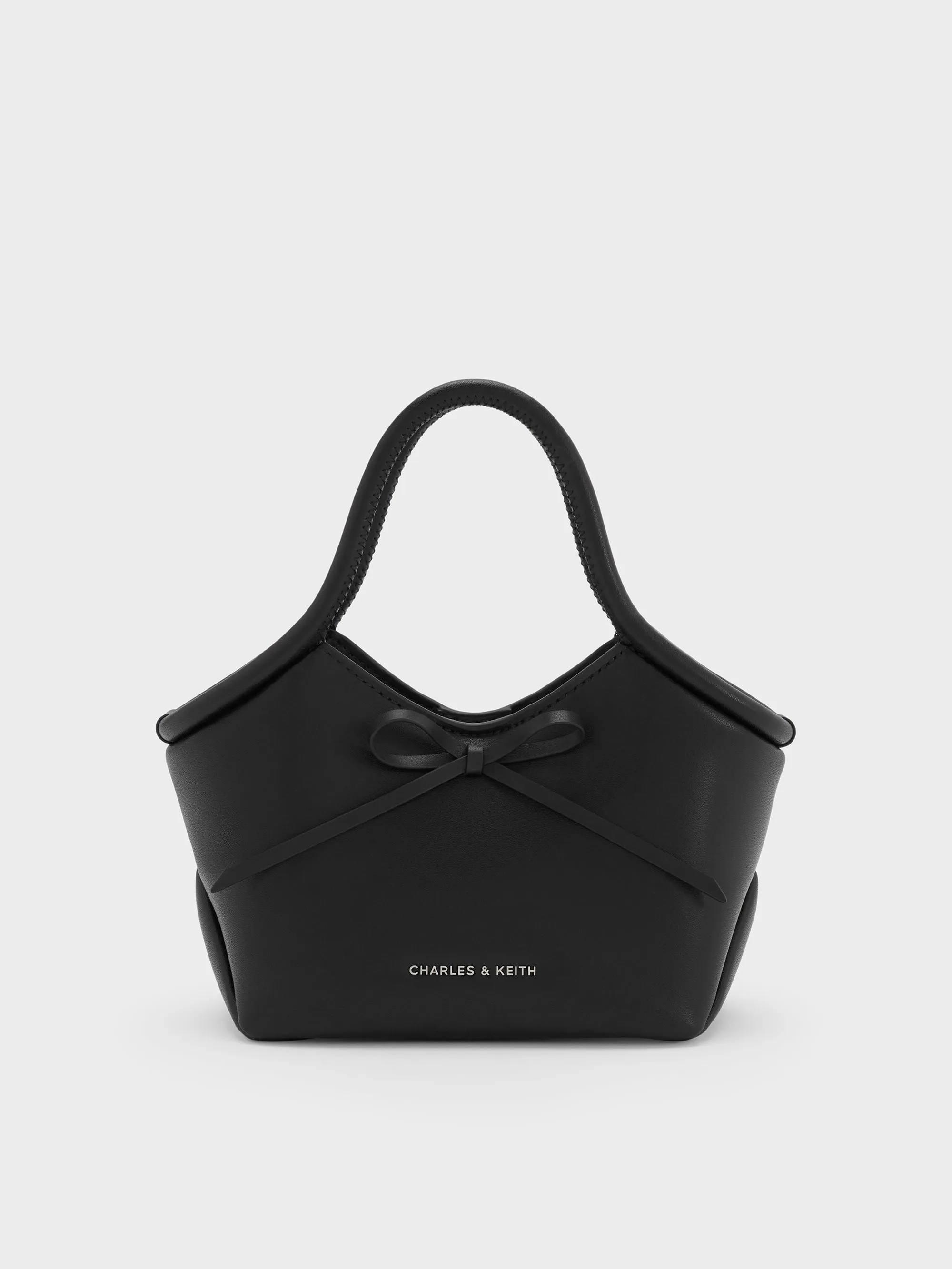 CHARLES & KEITH - Hazel Bow Tubular Top Handle Bag sold by Charles & Keith