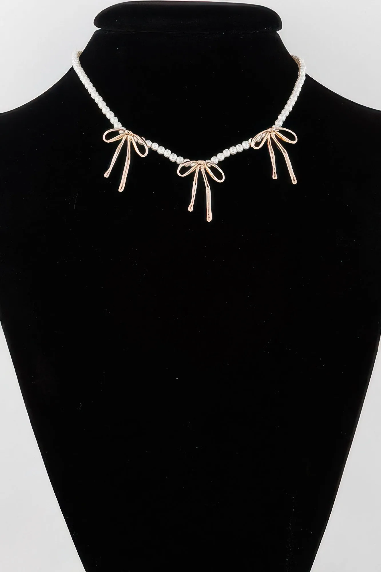 Pearl And Metal Ribbon Charm Necklace sold by Unique Kulture