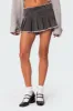 Nalani Washed Denim Pleated Mini Skort sold by Edikted