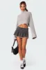 Nalani Washed Denim Pleated Mini Skort sold by Edikted