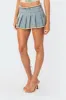 Nalani Washed Denim Pleated Mini Skort sold by Edikted