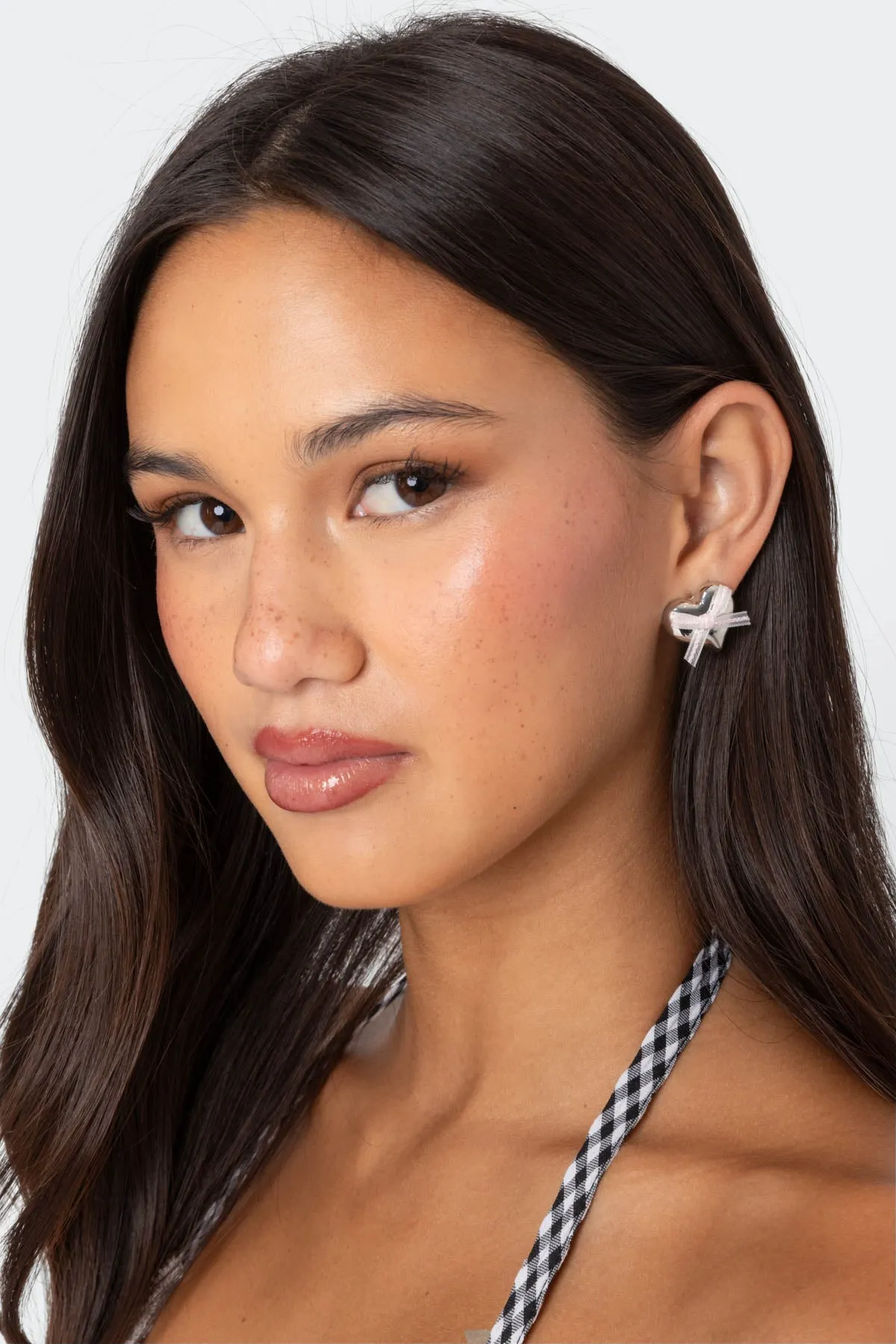 Heart & Bow Stud Earrings sold by Edikted