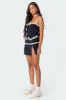 Heiress Eyelet Mini Skirt sold by Edikted