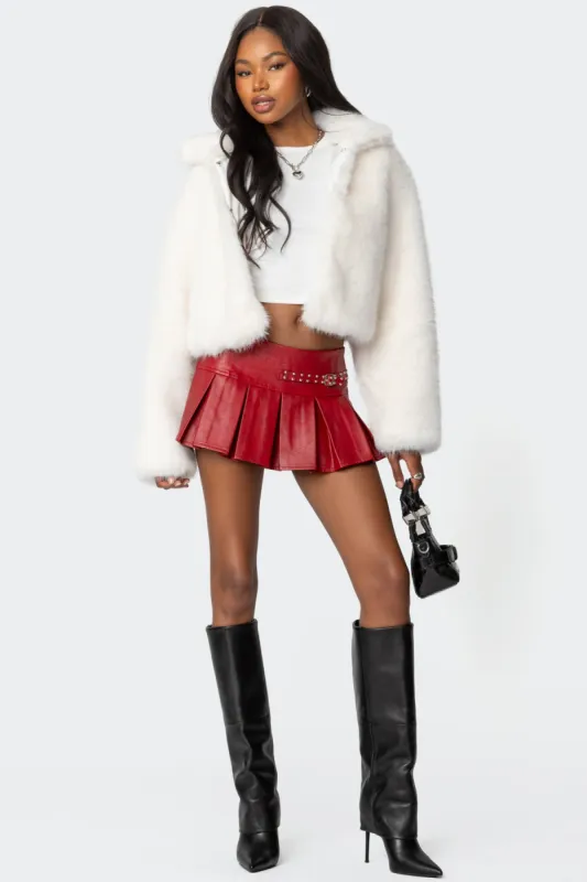 Carmine Faux Leather Pleated Mini Skirt sold by Edikted