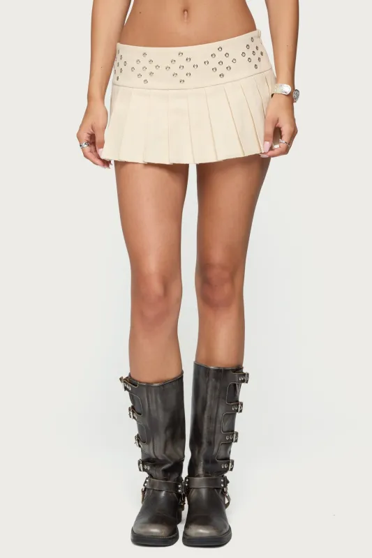 Lovina Grommet Pleated Mini Skort sold by Edikted