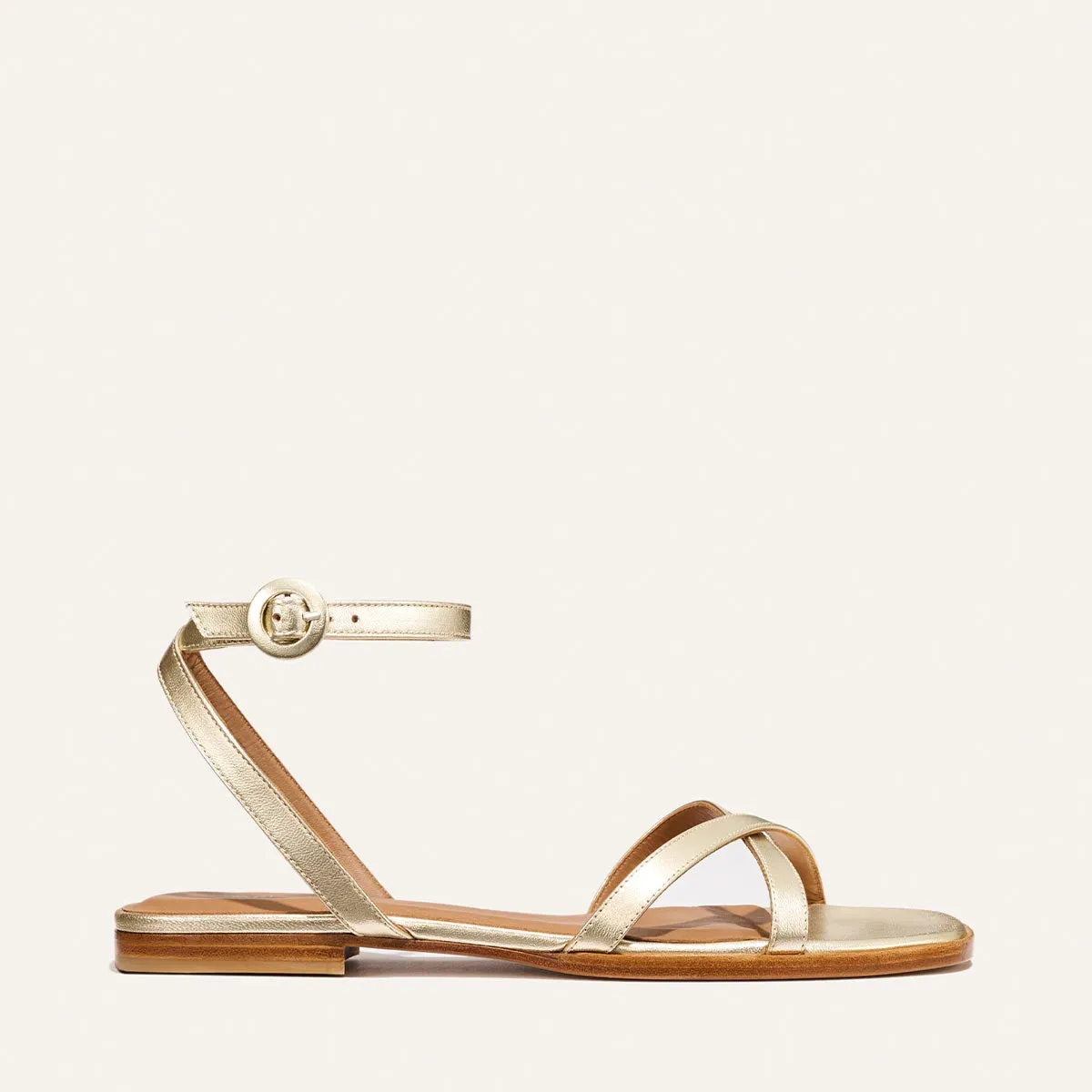 The Flat Sandal - Champagne Nappa sold by Margaux