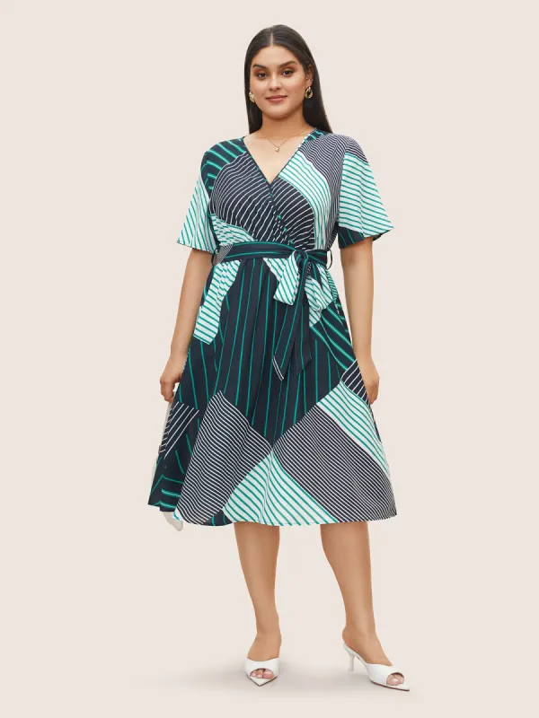 Striped Geometric Surplice Neck Belted Dress sold by Bloomchic