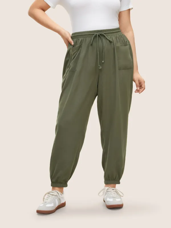 Solid Patched Pocket Elastic Waist Drawstring Pants sold by Bloomchic