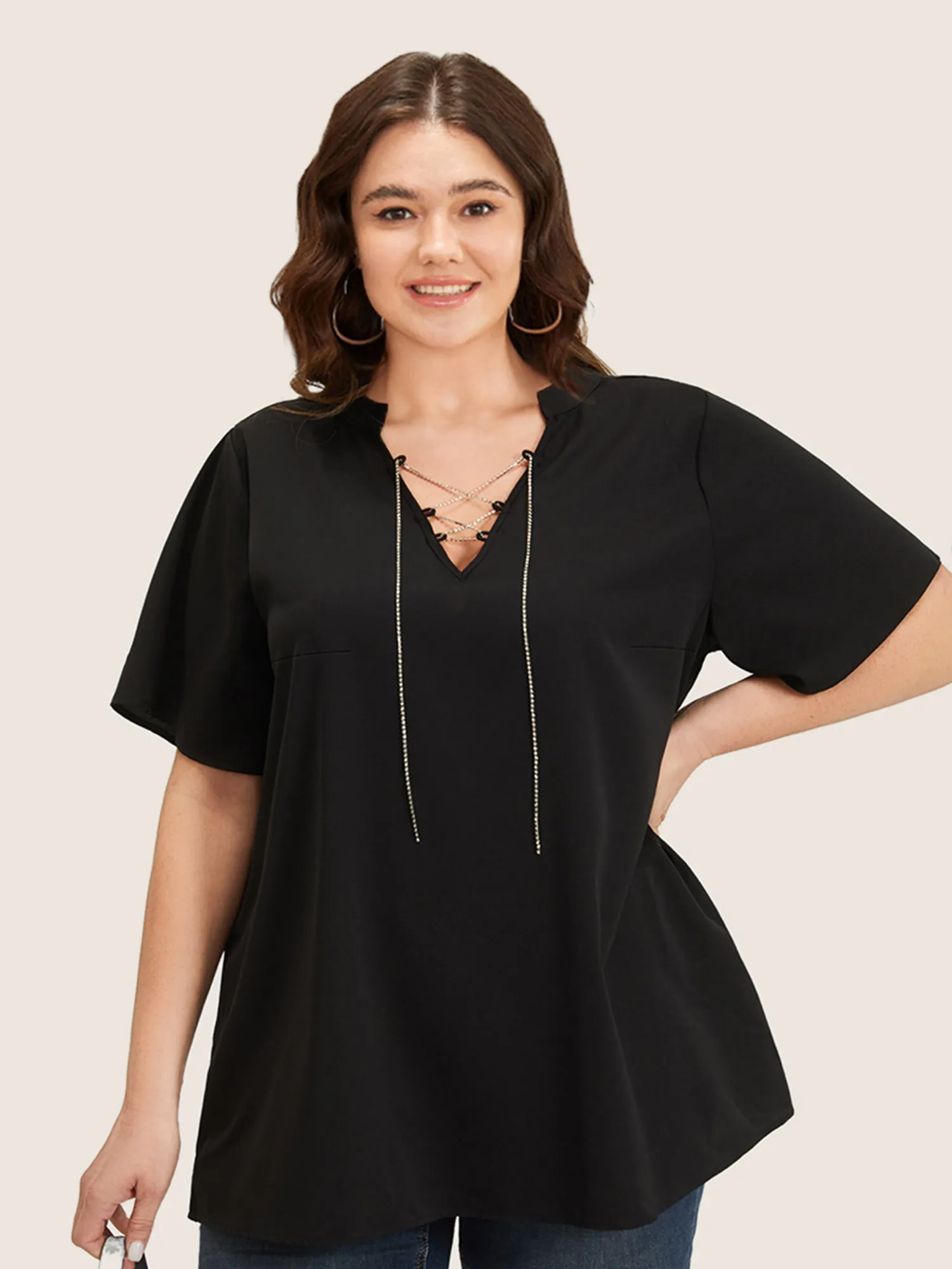 Solid Crisscross Notched Metal Decor Blouse sold by Bloomchic