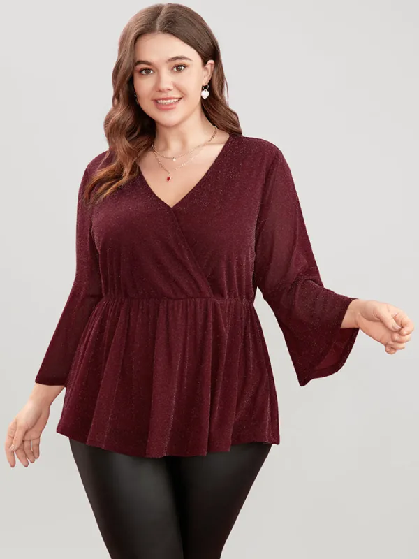 Solid Surplice Neck Bell Sleeve Glitter Blouse sold by Bloomchic